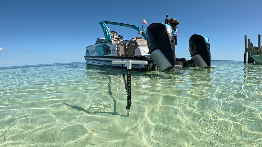 Pontoon boat anchored at a sandbar using a SandShark anchor